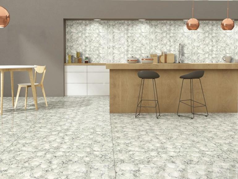 Open kitchen design with a wooden island, marble-style tiles, pendant lighting, and stylish seating.
